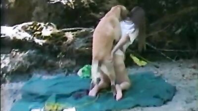 Housewife fucks dog on rocks at the beach