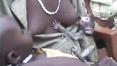 Mother breastfeeding a monkey