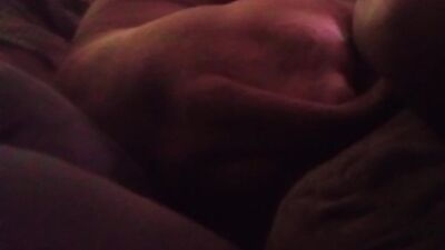 Couple and dog laying down on couch together