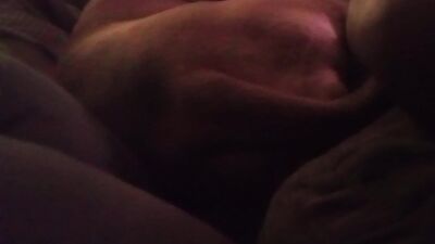 Couple and dog laying down on couch together