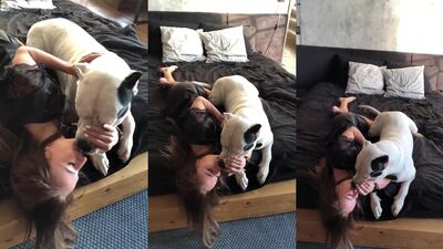 Sonya kisses dog on bed